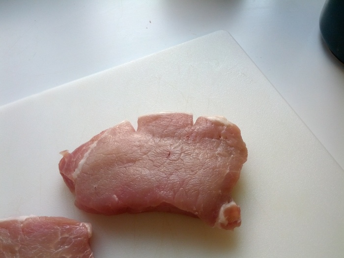 These two small slits will stop your pork chops from curling!  Be sure to cut only the fat and  the silver skin.